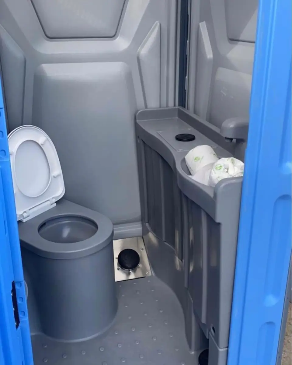 Inside a deluxe flushing porta potty with sink