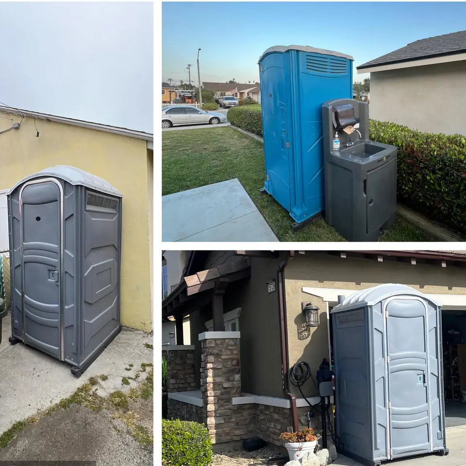 Gray porta potty set beside a house on a driveway