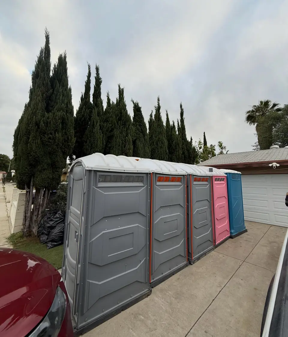 Row of porta potties lined up on a driveway